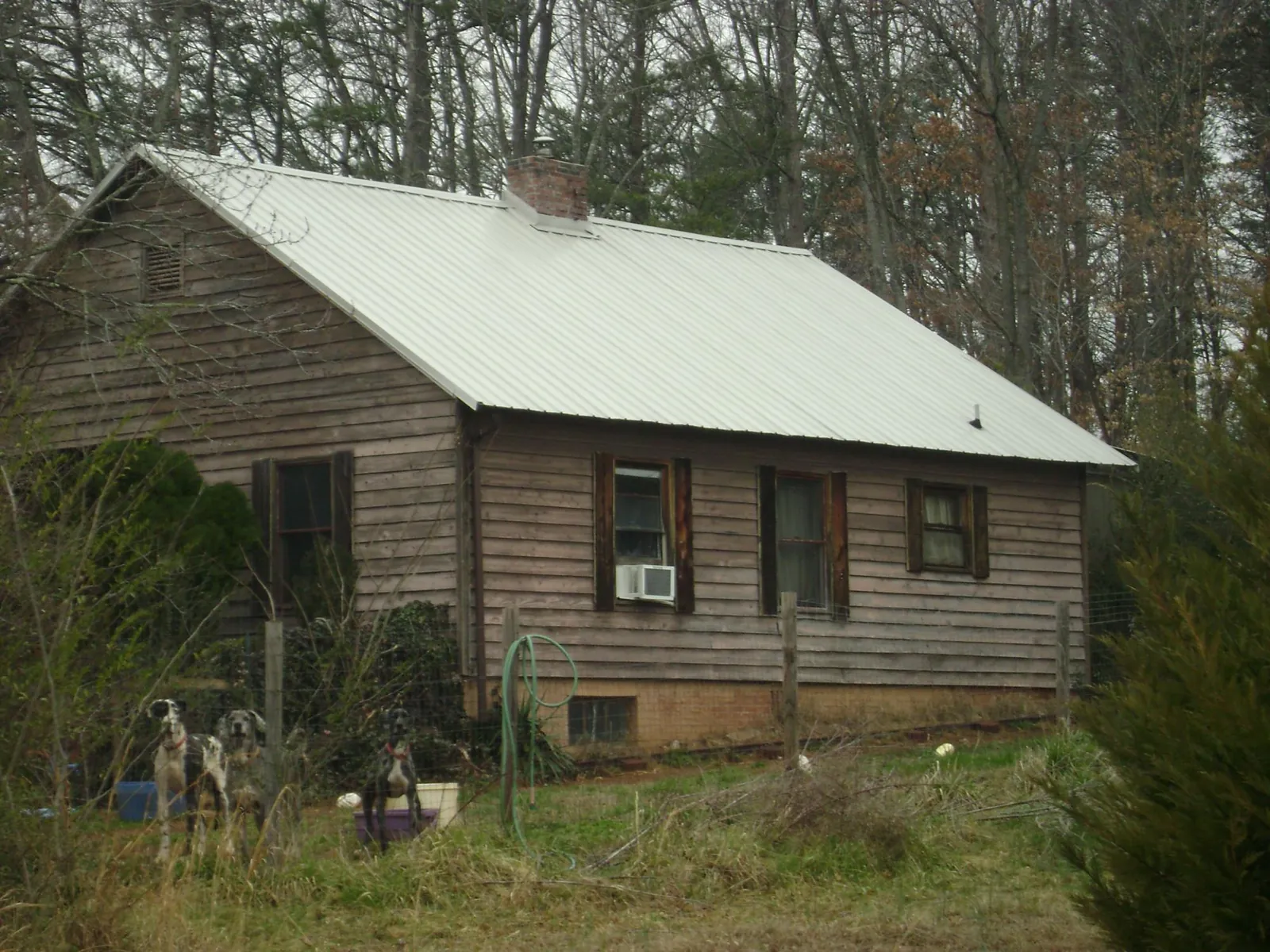 White metal roof on an old wood sided farmhouse, from a Metal Roof Installation job in Amma